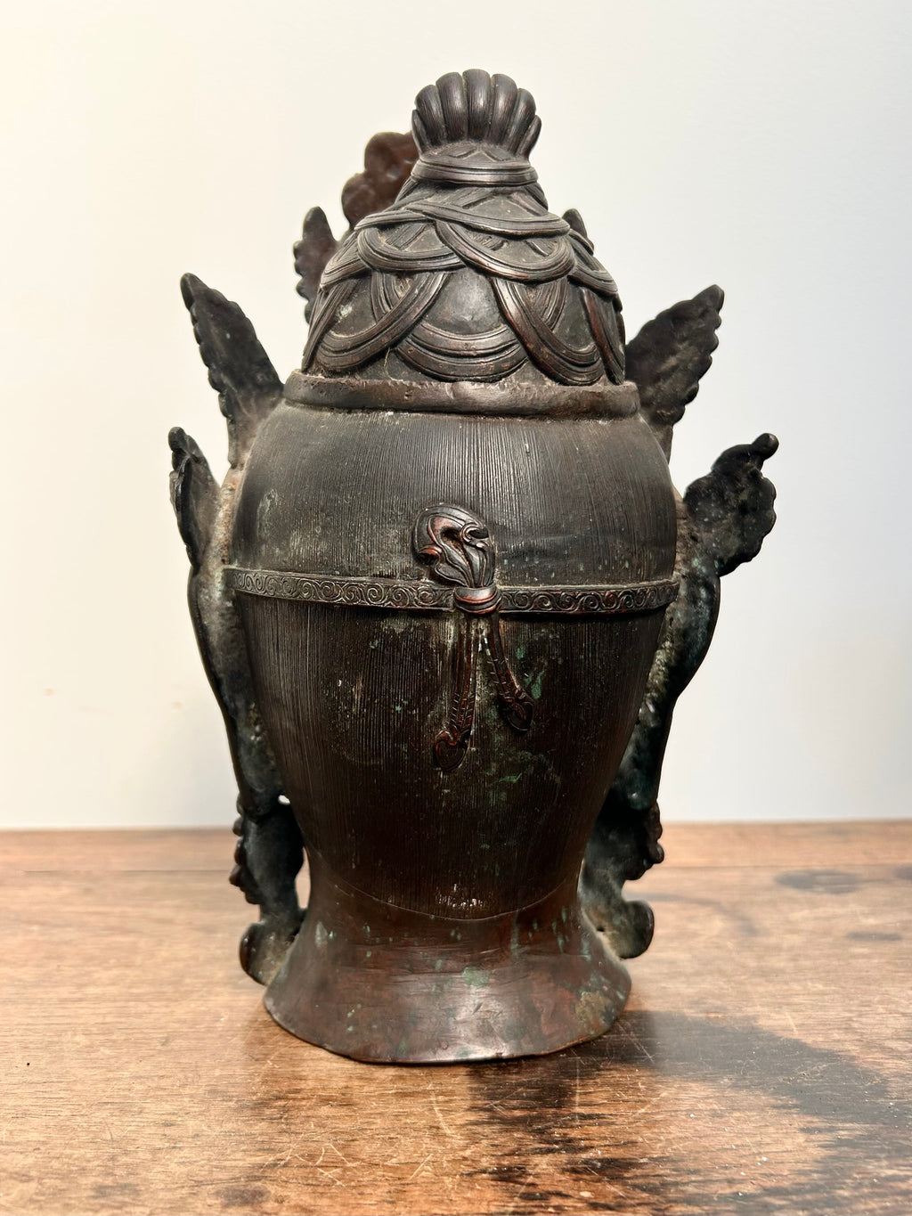 Bronze Tara statue back of head with decorative elements on a wooden surface