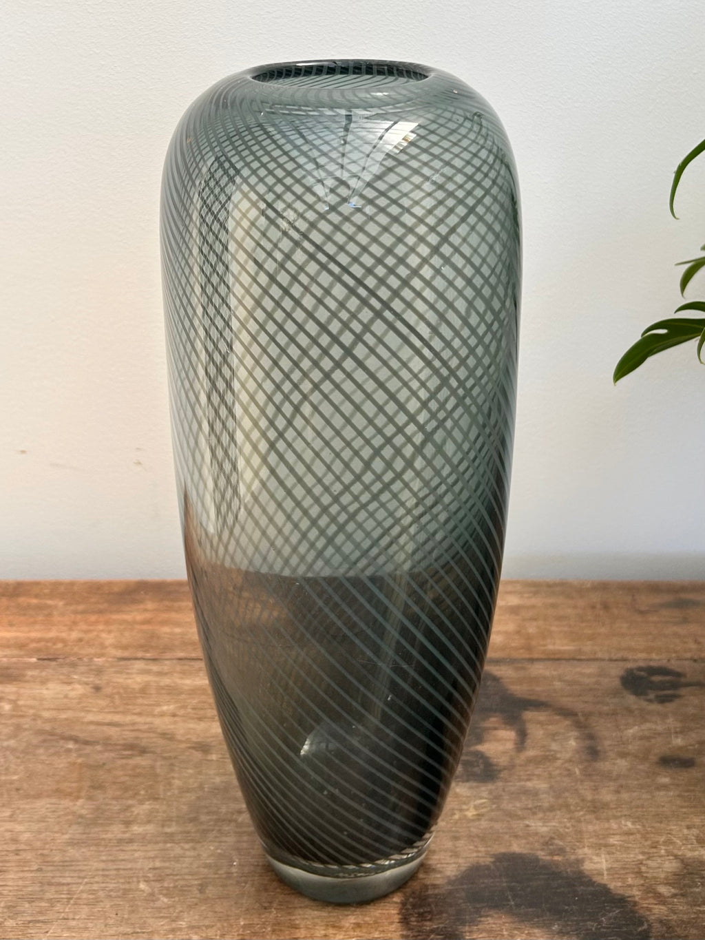 Decorative vase with textured design on a wooden surface